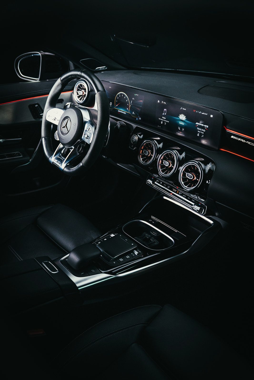 AMG steering wheel, turbine air vents and centre console in low light