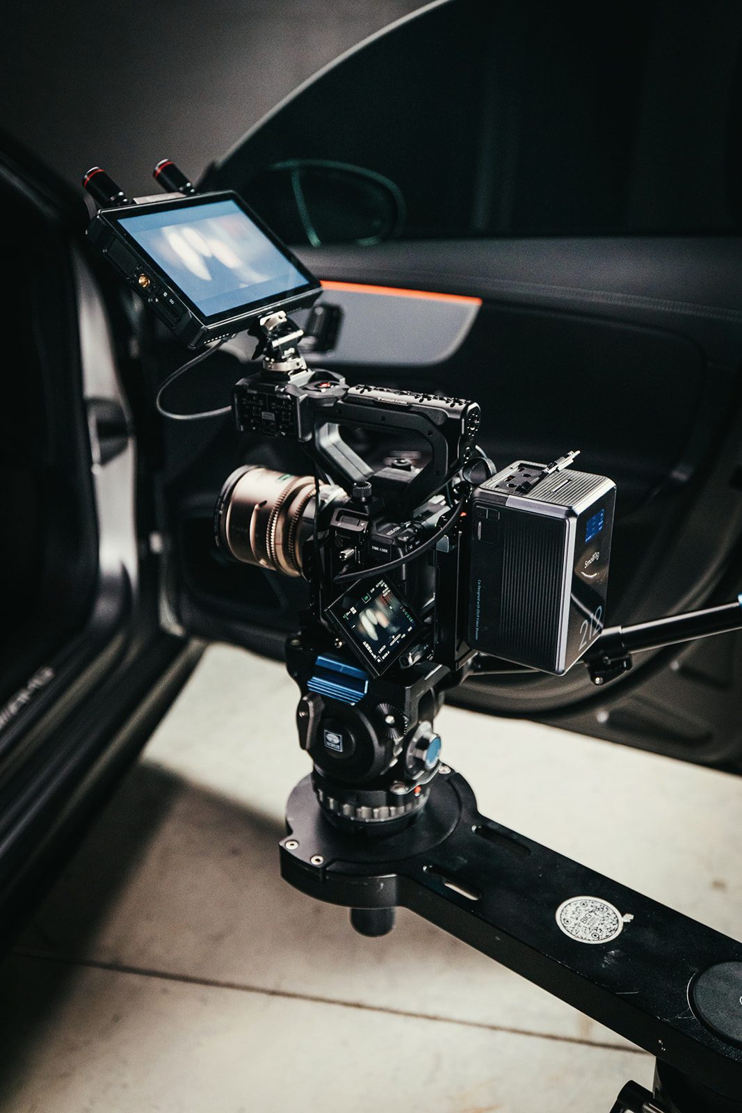 Cinema camera rigged on an arm inside the car