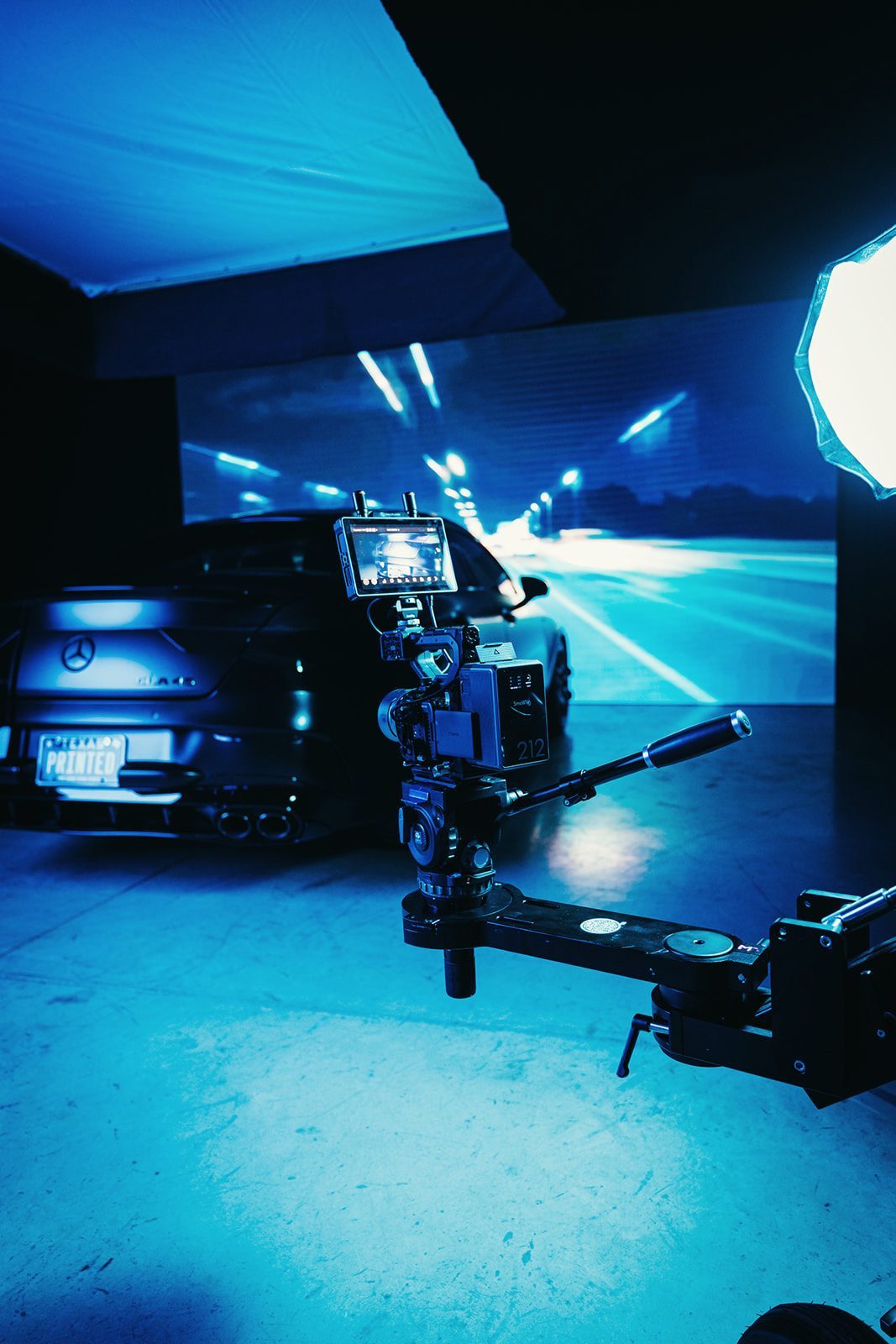 Camera crane filming a car in front of an LED wall
